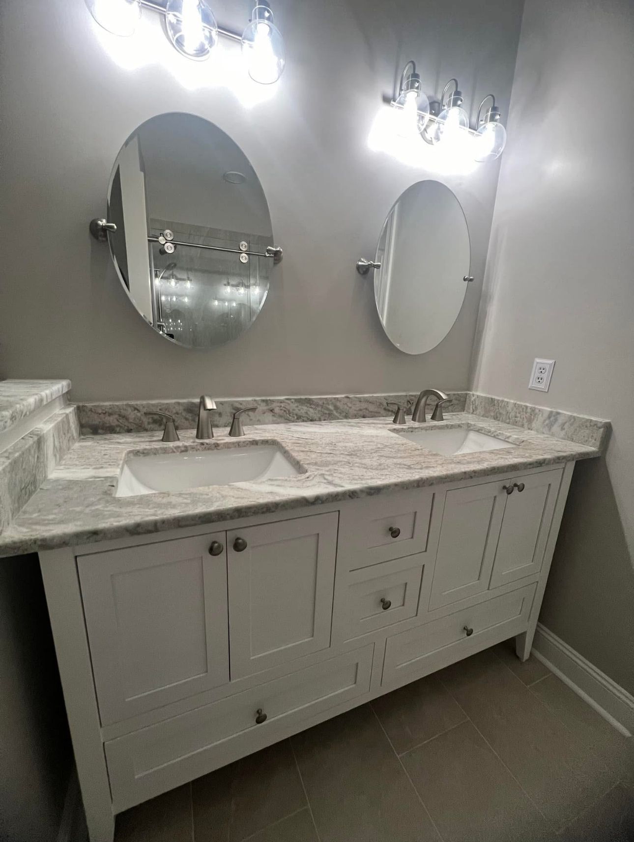 A bathroom with two sinks and two mirrors.