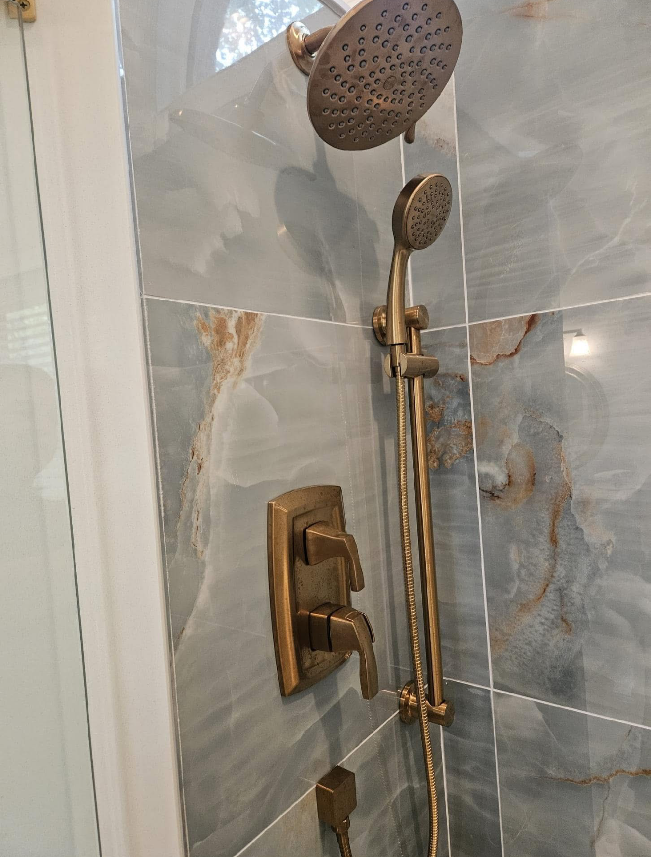 A close up of a shower head in a bathroom.