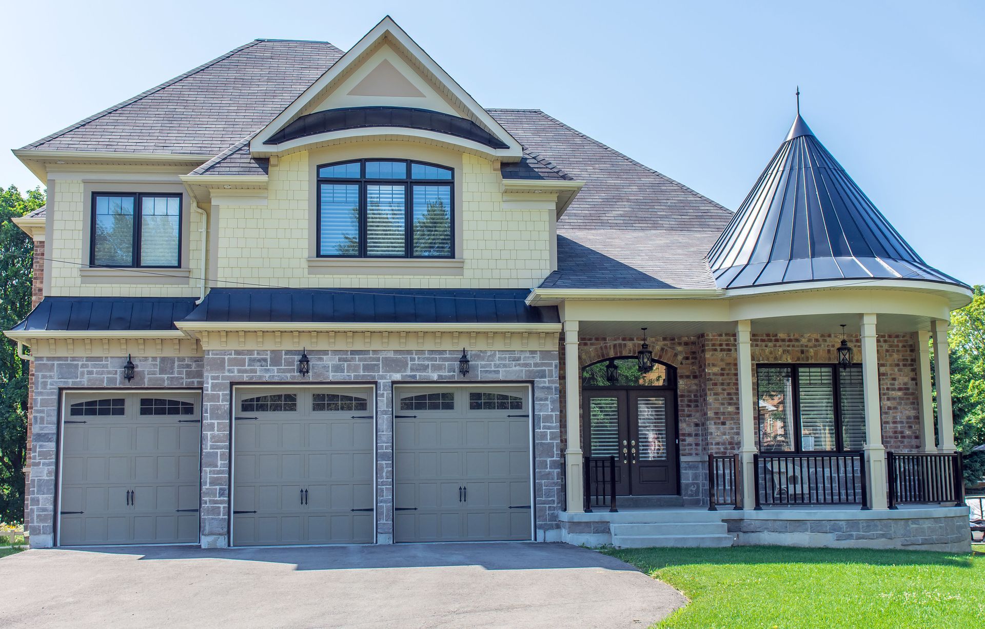 Two-story suburban house with gray garage doors, yellow siding, and a covered porch.