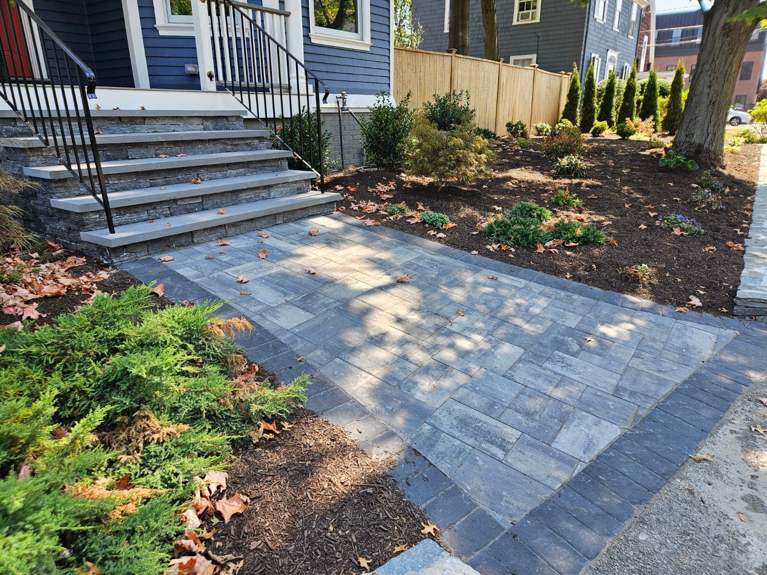 A brick walkway leading to the front door of a house.