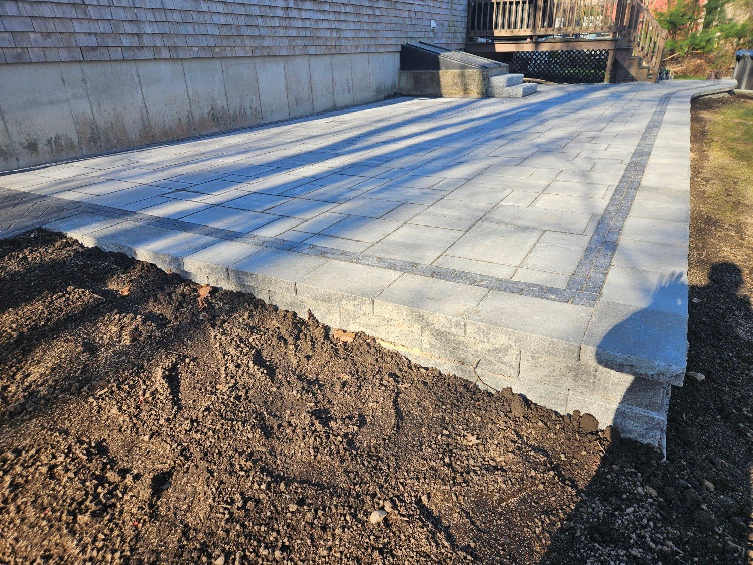 A patio is being built in front of a house.