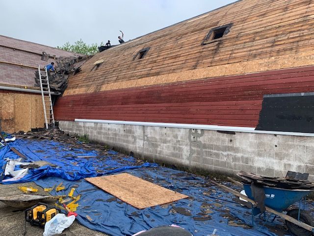 A roof is being removed from a building.