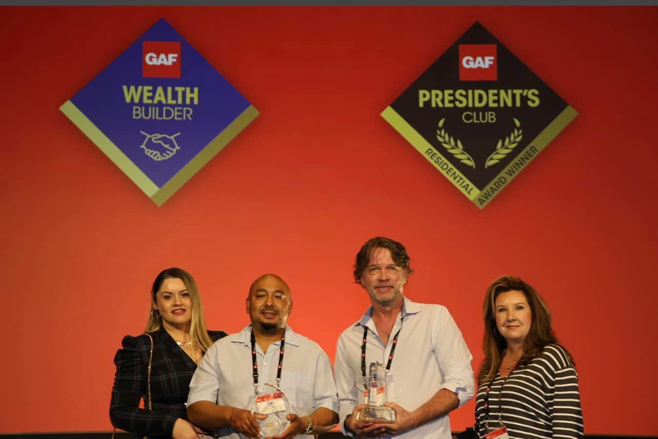 A group of people standing in front of a sign that says wealth builder