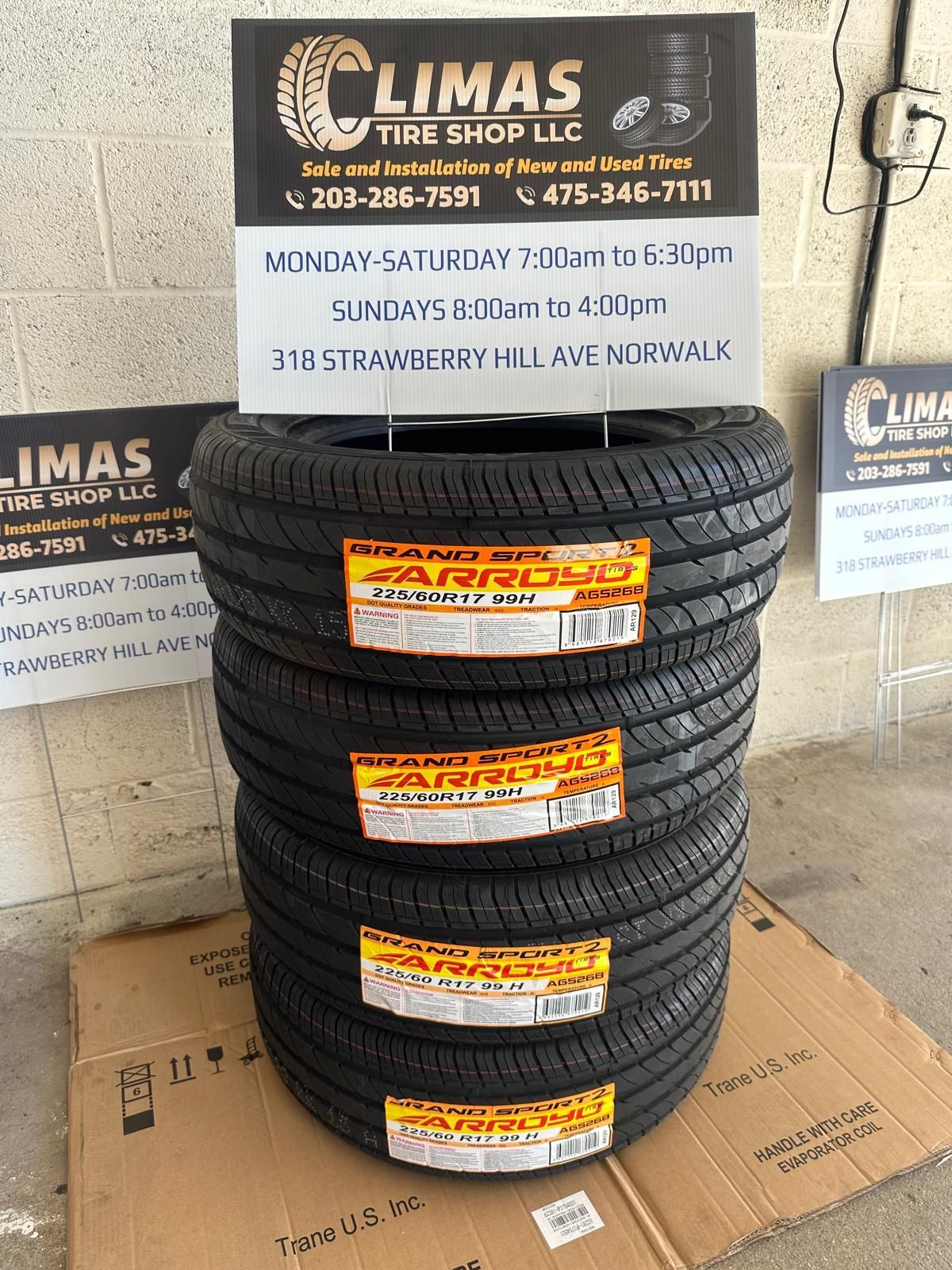 A stack of tires is sitting on top of a cardboard box.