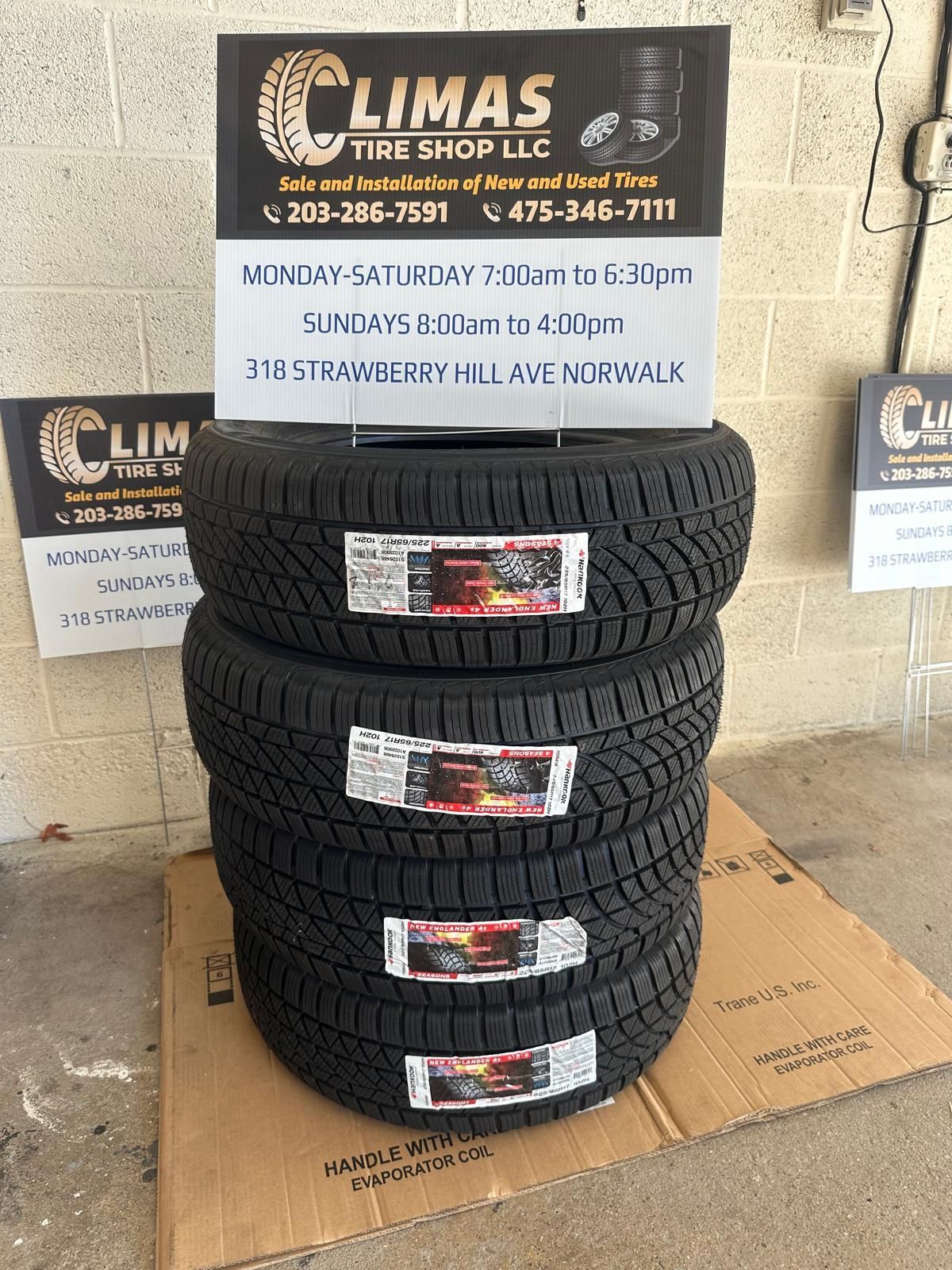 A stack of tires sitting on top of a cardboard box.