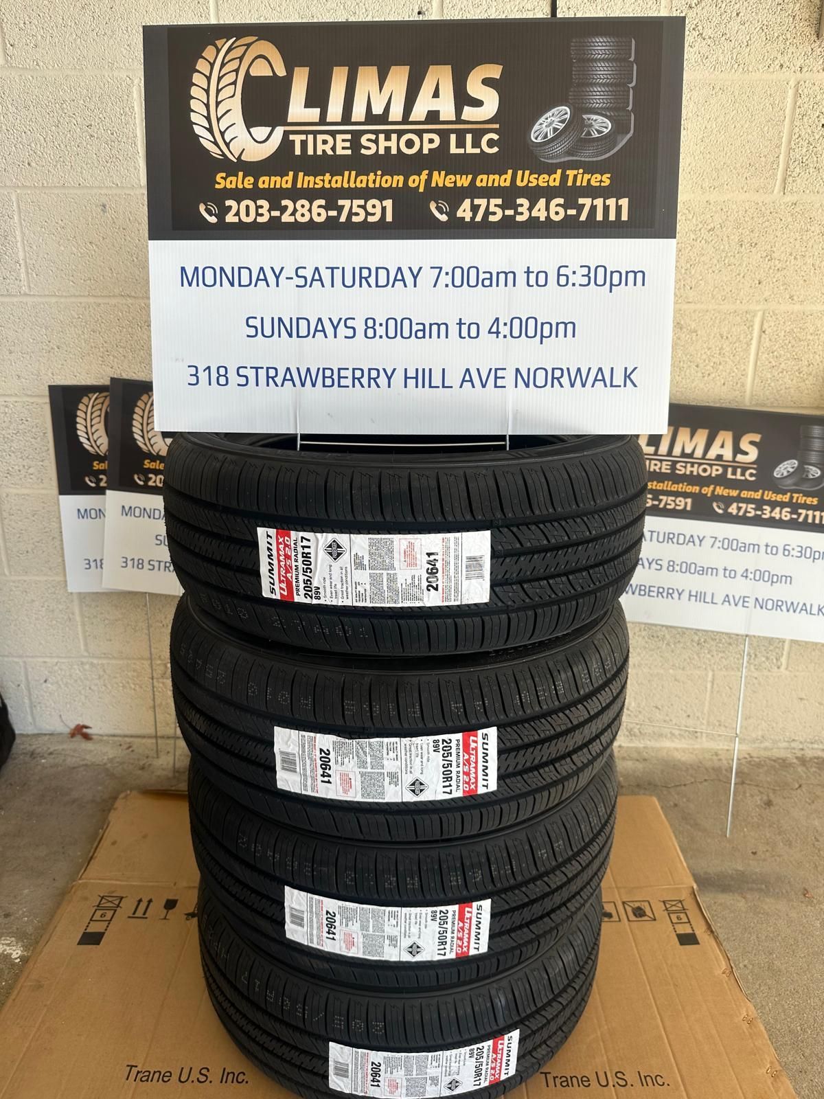 A stack of tires sitting on top of a cardboard box.