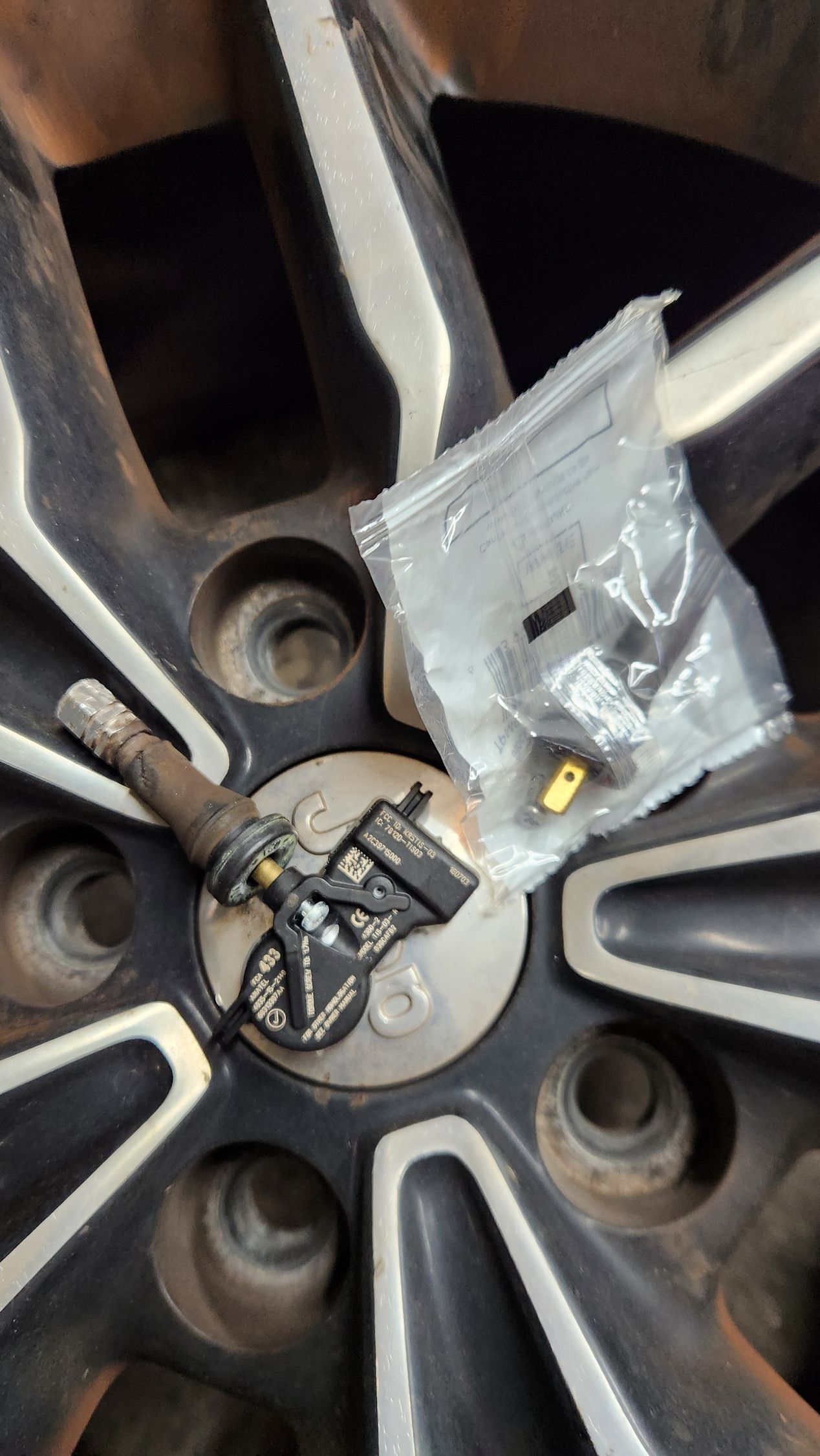 A close up of a tire with a bag of pills on it.