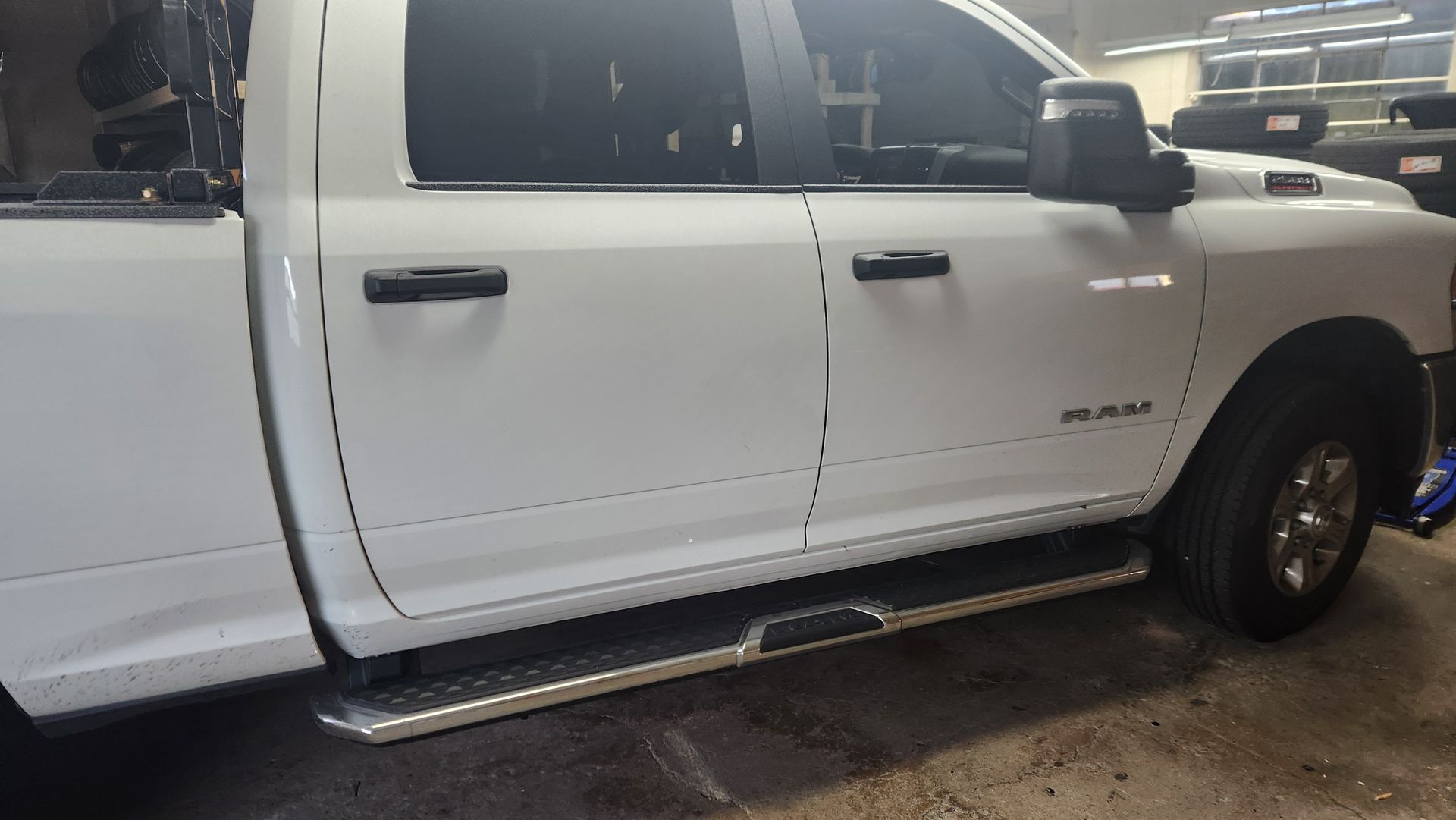 A white dodge ram truck is parked in a garage.