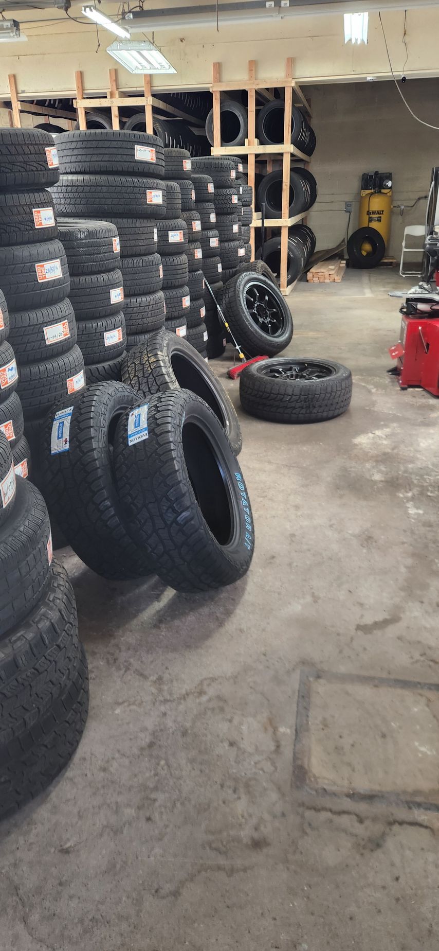 A warehouse filled with lots of tires stacked on top of each other.