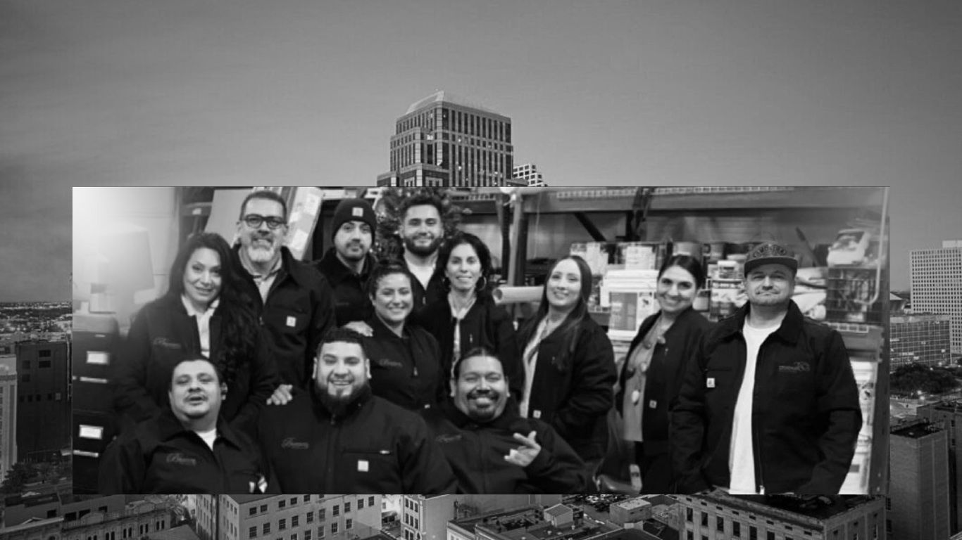 A black and white photo of a group of people posing for a picture.