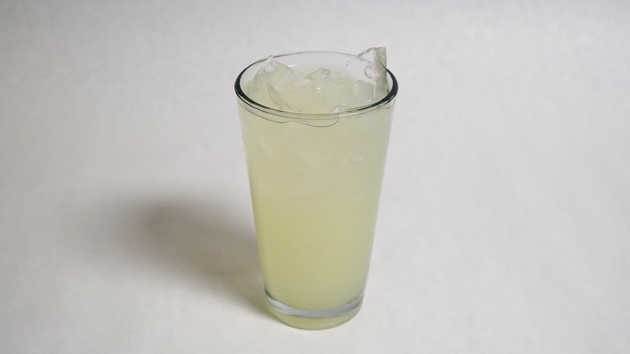 Tall glass of lemonade with ice.