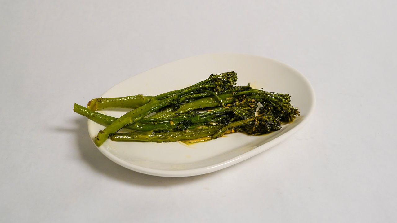 Green vegetables on a white, oval plate.