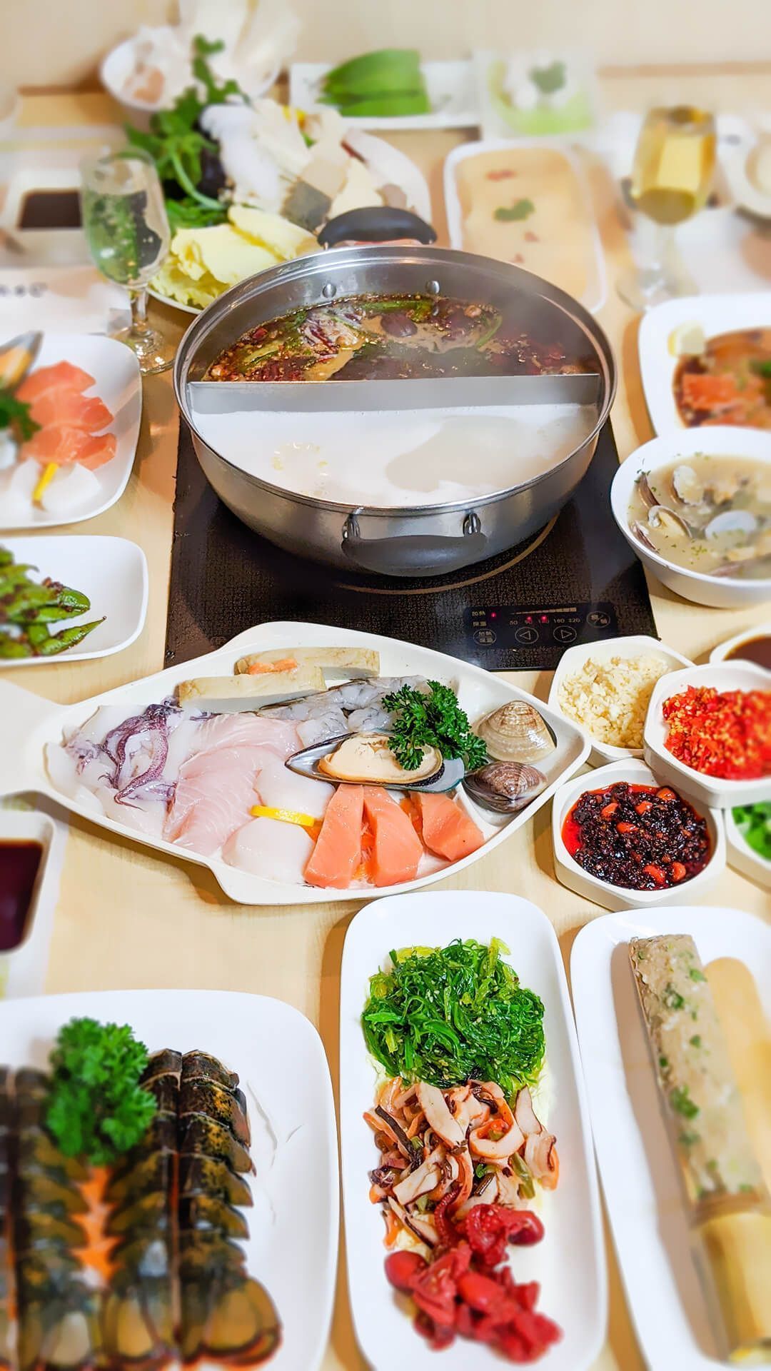 a table topped with plates of food and a pot of soup