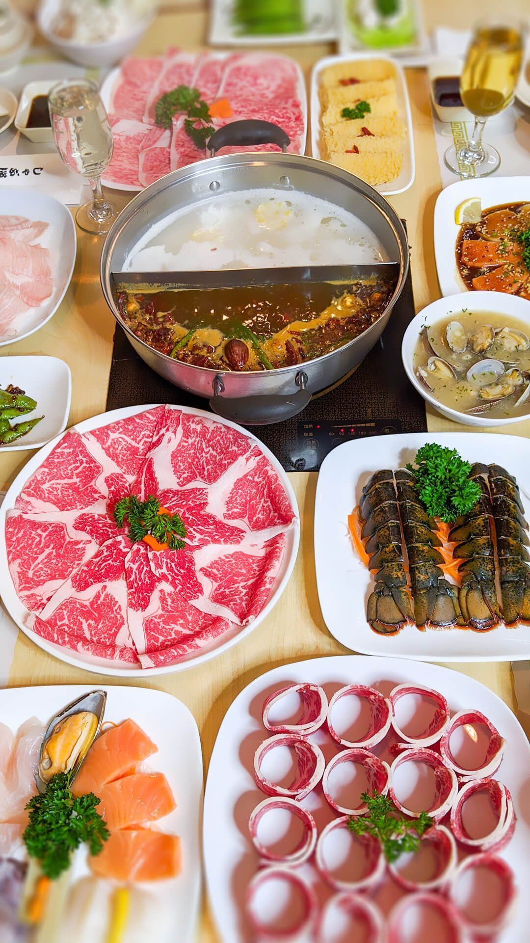 a table topped with plates of food and a pot of soup