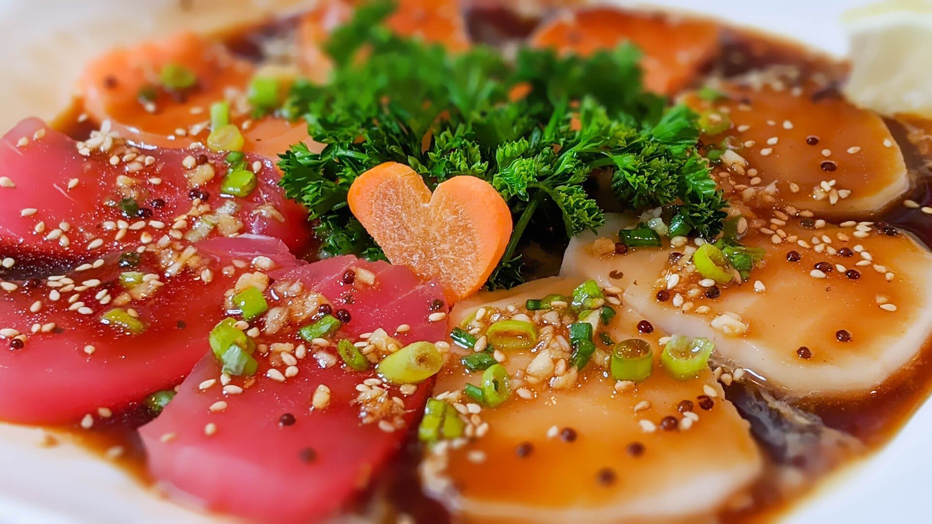 a close up of a plate of food with a heart shaped carrot on top