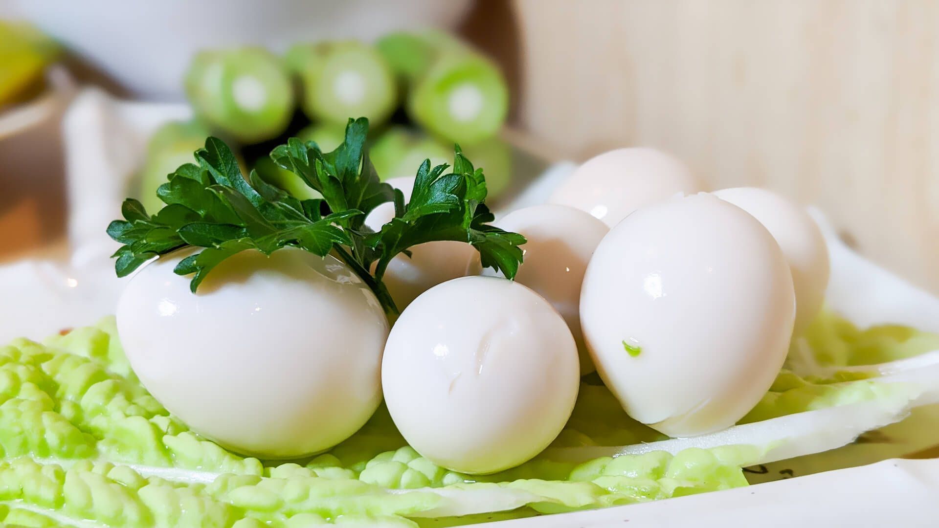 hard boiled eggs on a plate with lettuce and parsley