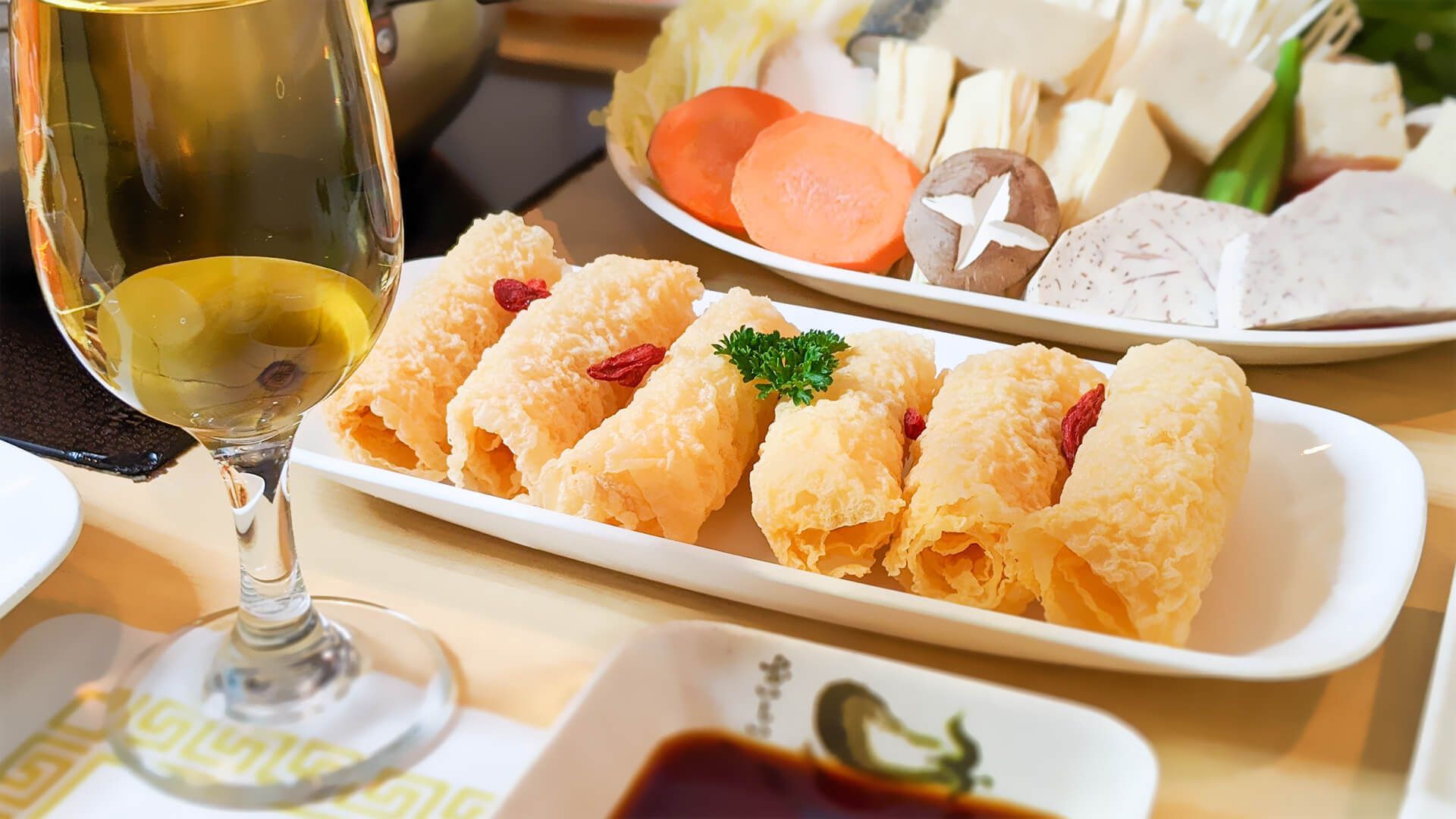 a plate of food and a glass of wine on a table