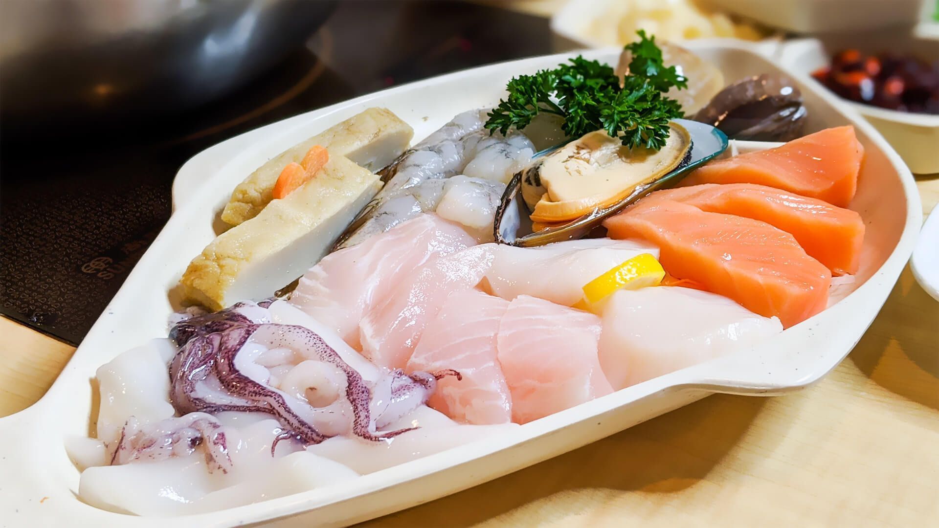 a white plate topped with a variety of seafood and vegetables