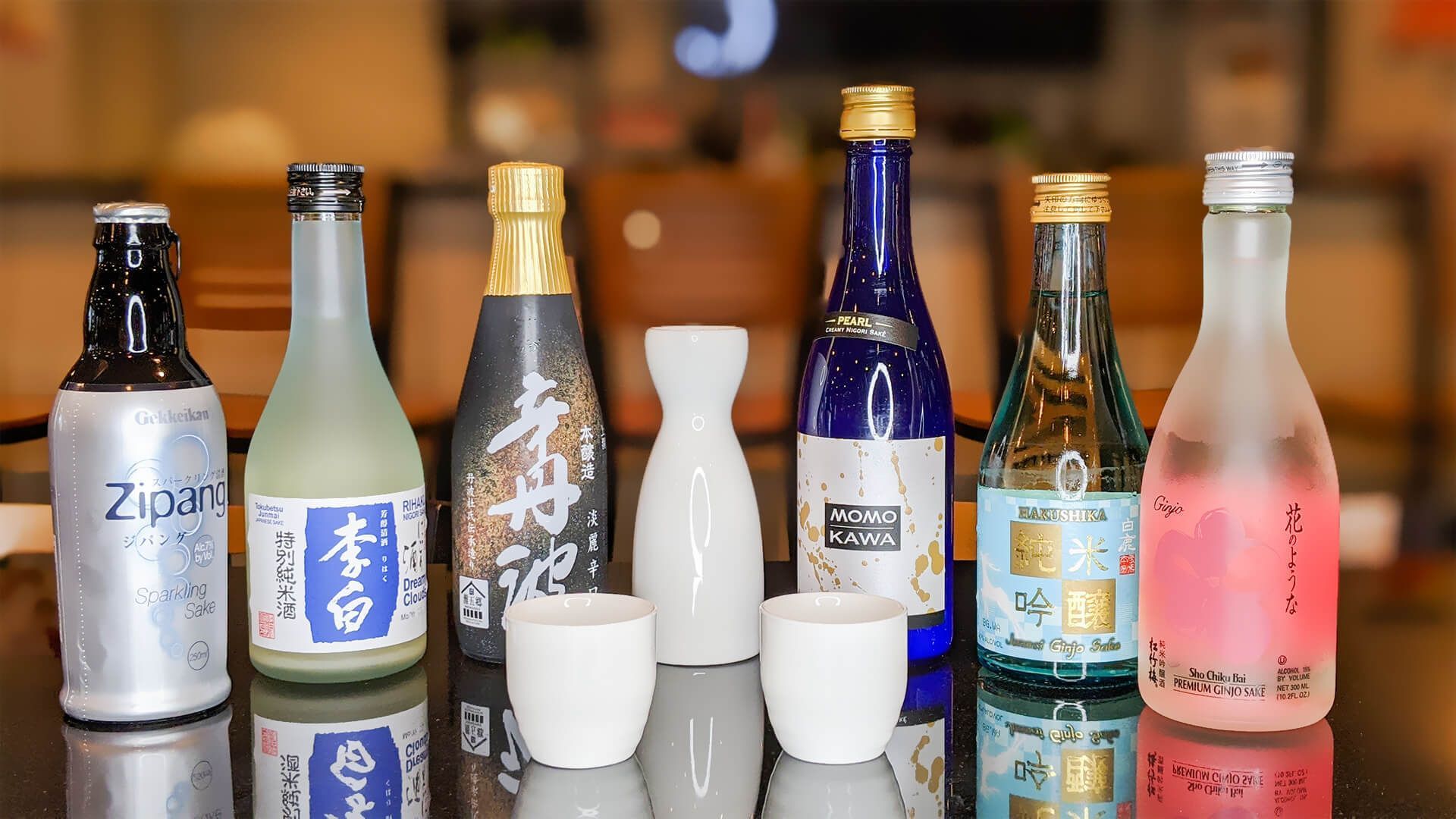 a table topped with bottles of alcohol and cups