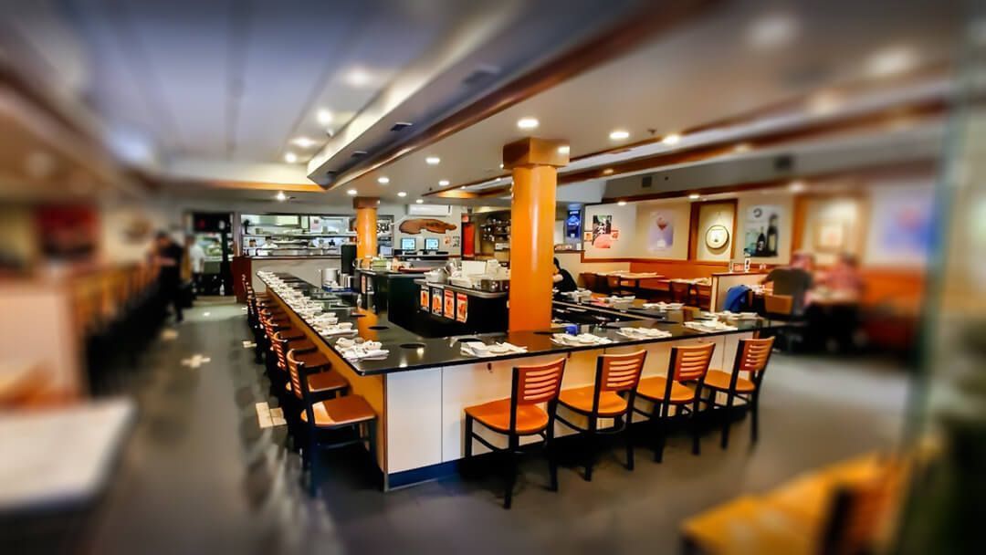 a picture of a restaurant with tables and chairs 