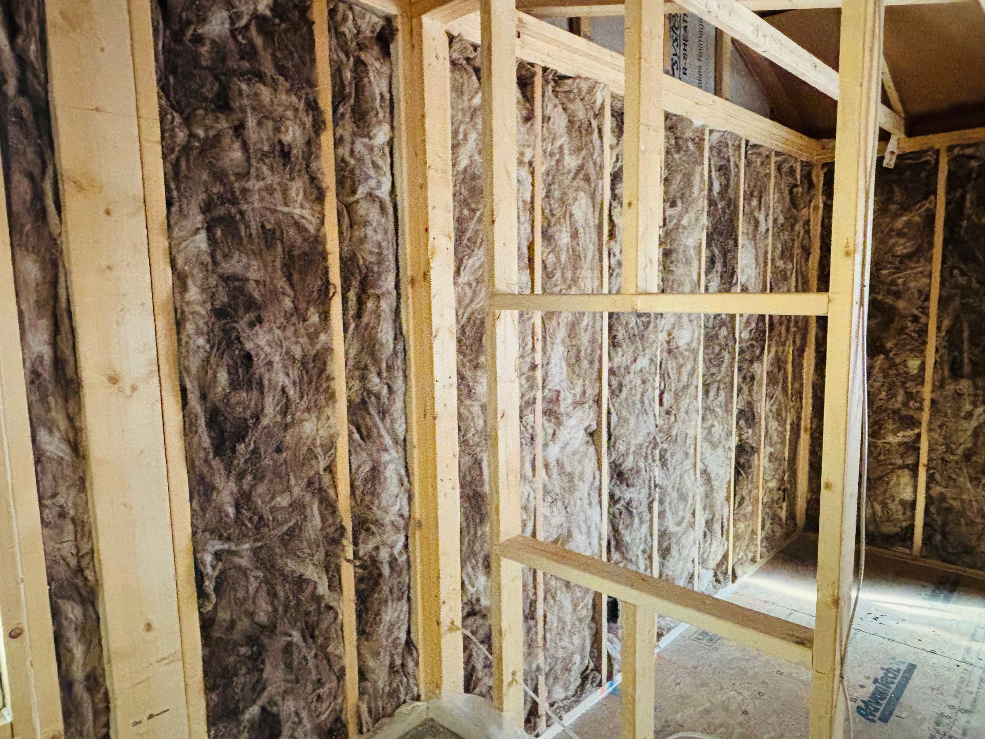 Wooden wall framing with insulation installed between studs; interior construction.
