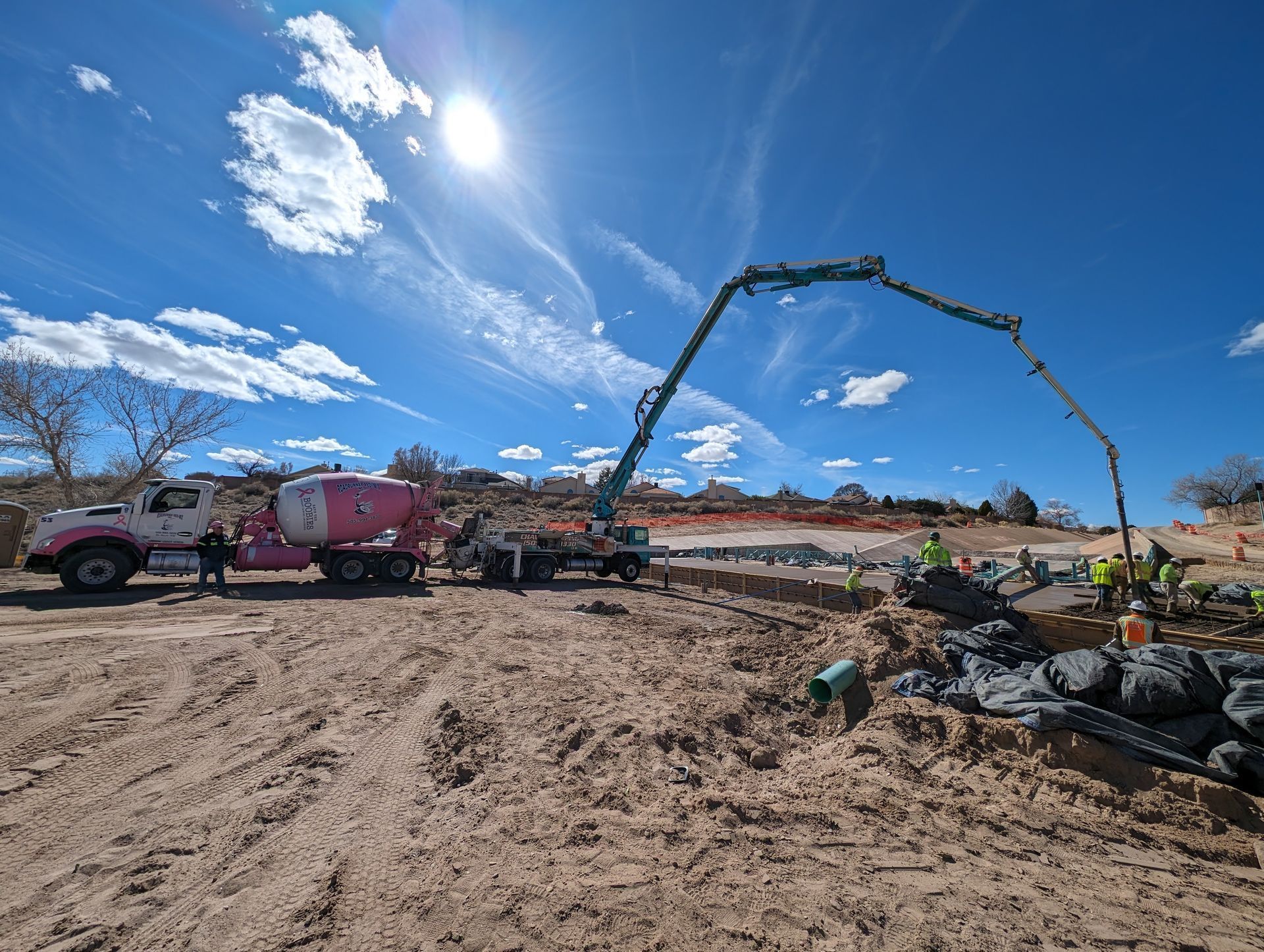 A concrete pump is being used to pour concrete on a construction site.