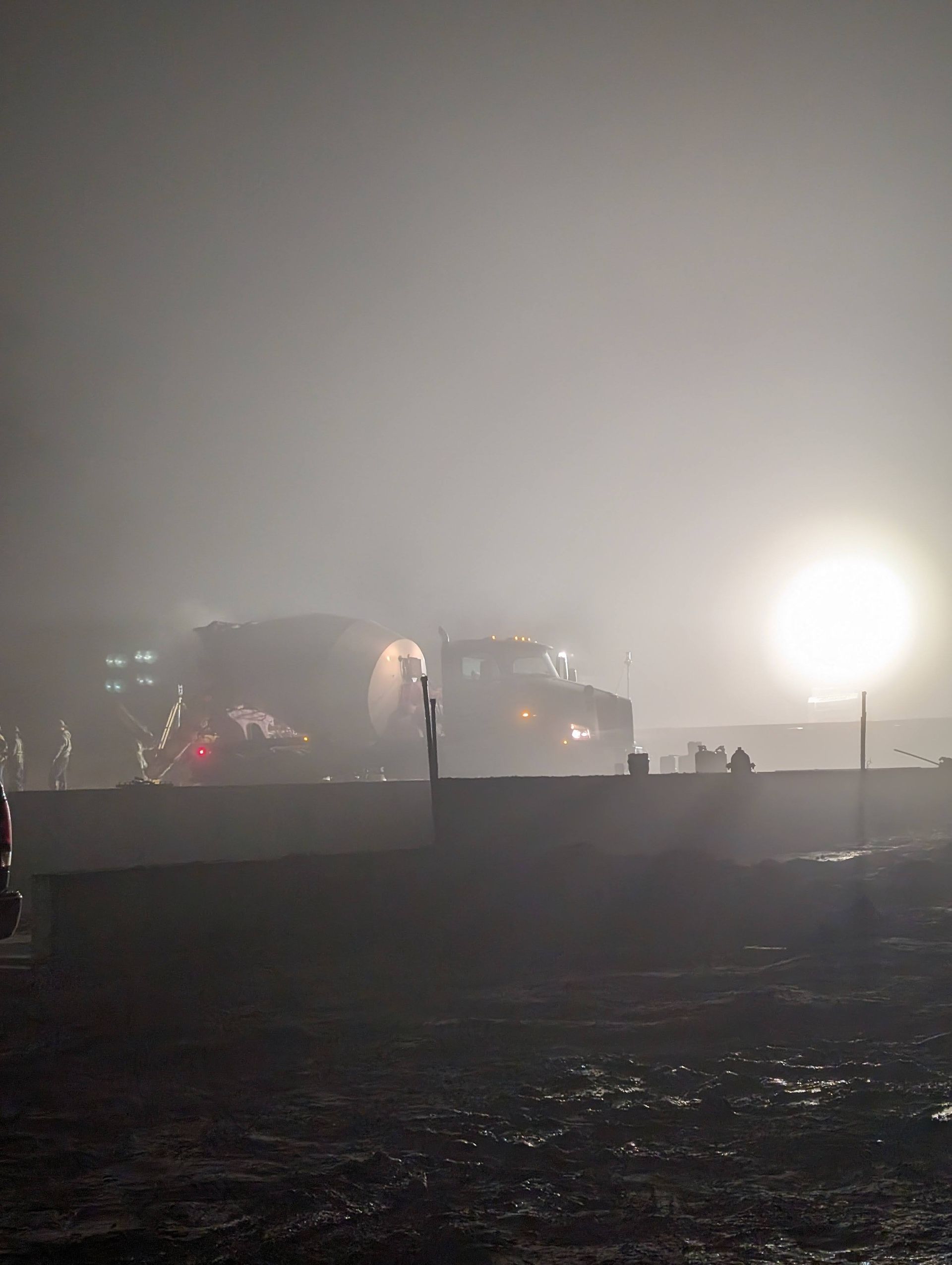 A foggy night with a lot of lights in the background.
