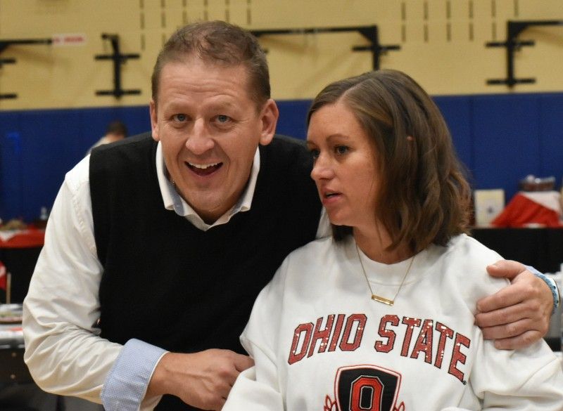A man is hugging a woman wearing an ohio state sweatshirt