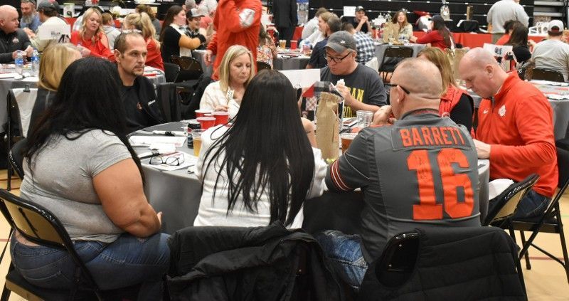 A group of people are sitting at tables in a room.