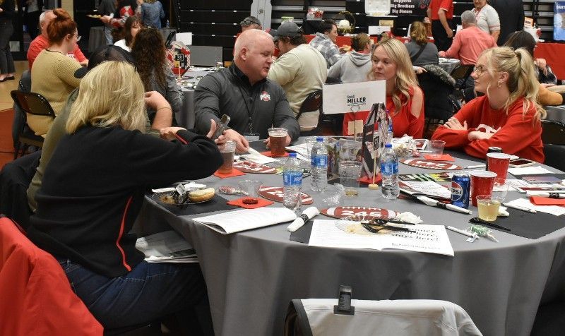 A group of people are sitting at tables in a room.