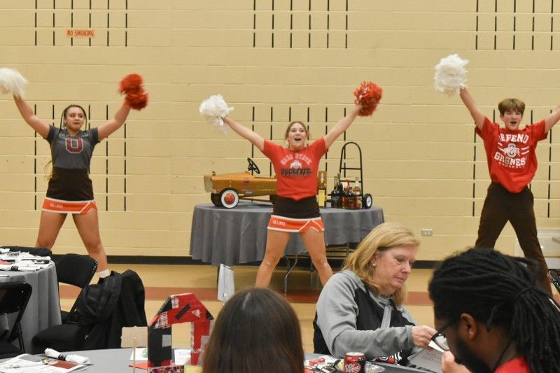 A group of cheerleaders are performing in a gym