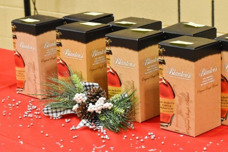 A bunch of boxes of bourbon are sitting on a table.