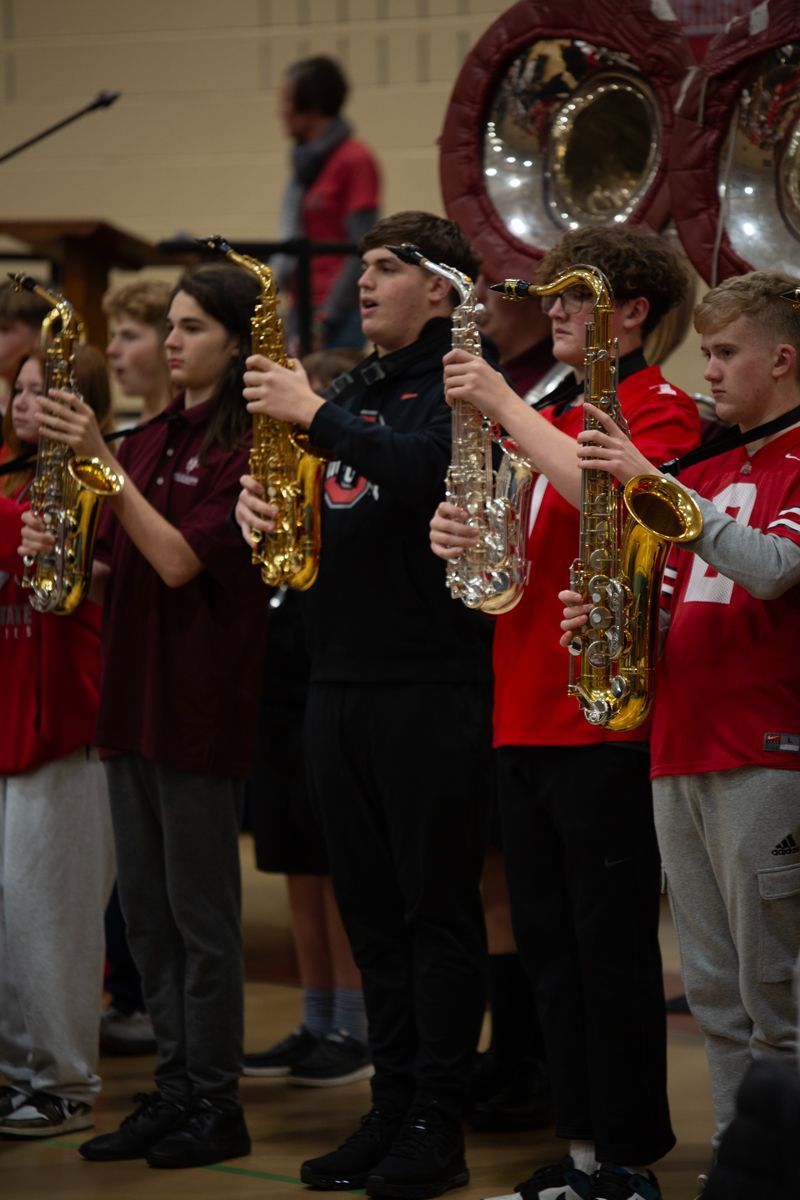 A group of young people are playing saxophones in a band.