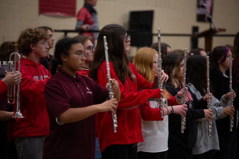 A group of young people are playing flutes in a band.