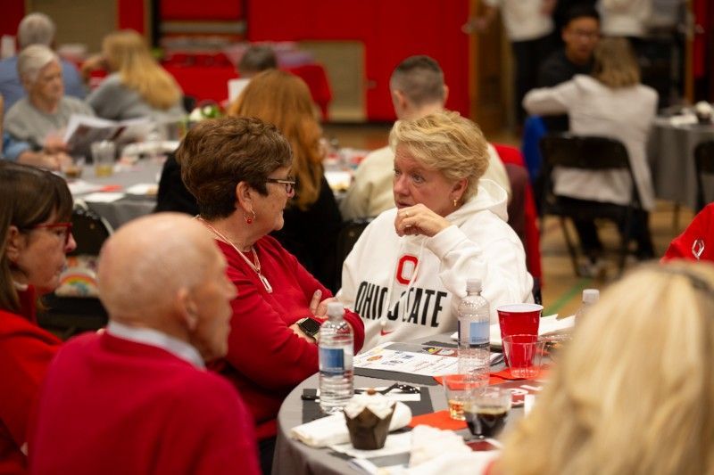 A group of people are sitting at tables in a room.