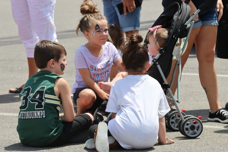 A boy wearing a green jersey with the number 34 on it