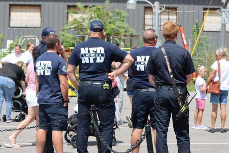 A group of mfd officers are standing in front of a crowd of people.