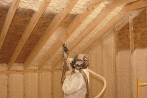A man applying spray foam insulation