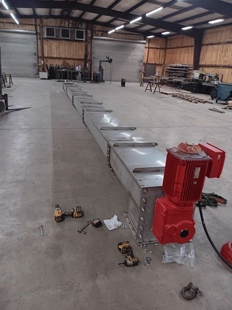 A large warehouse with a red motor on the floor