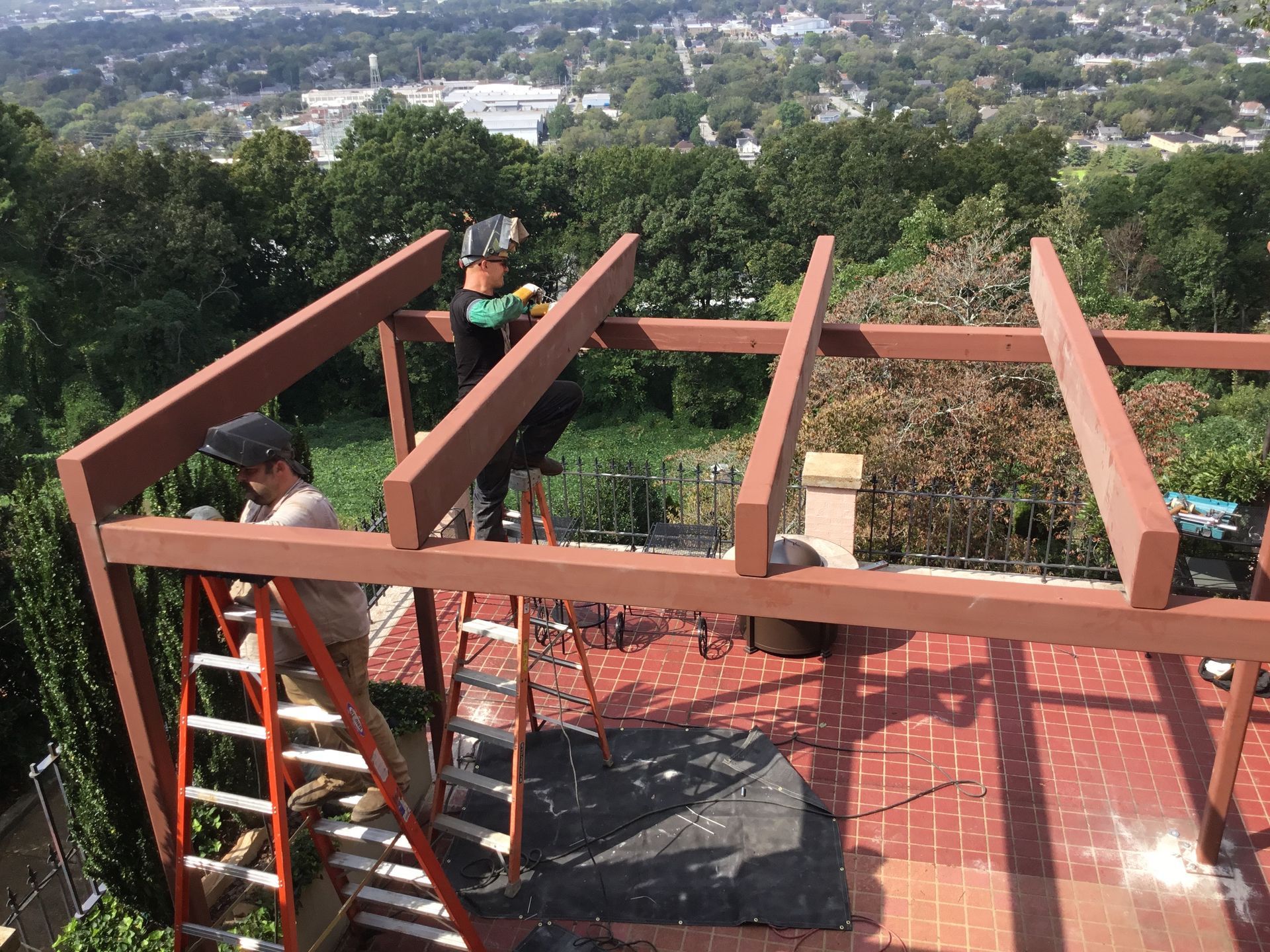two men are standing on a ladder
