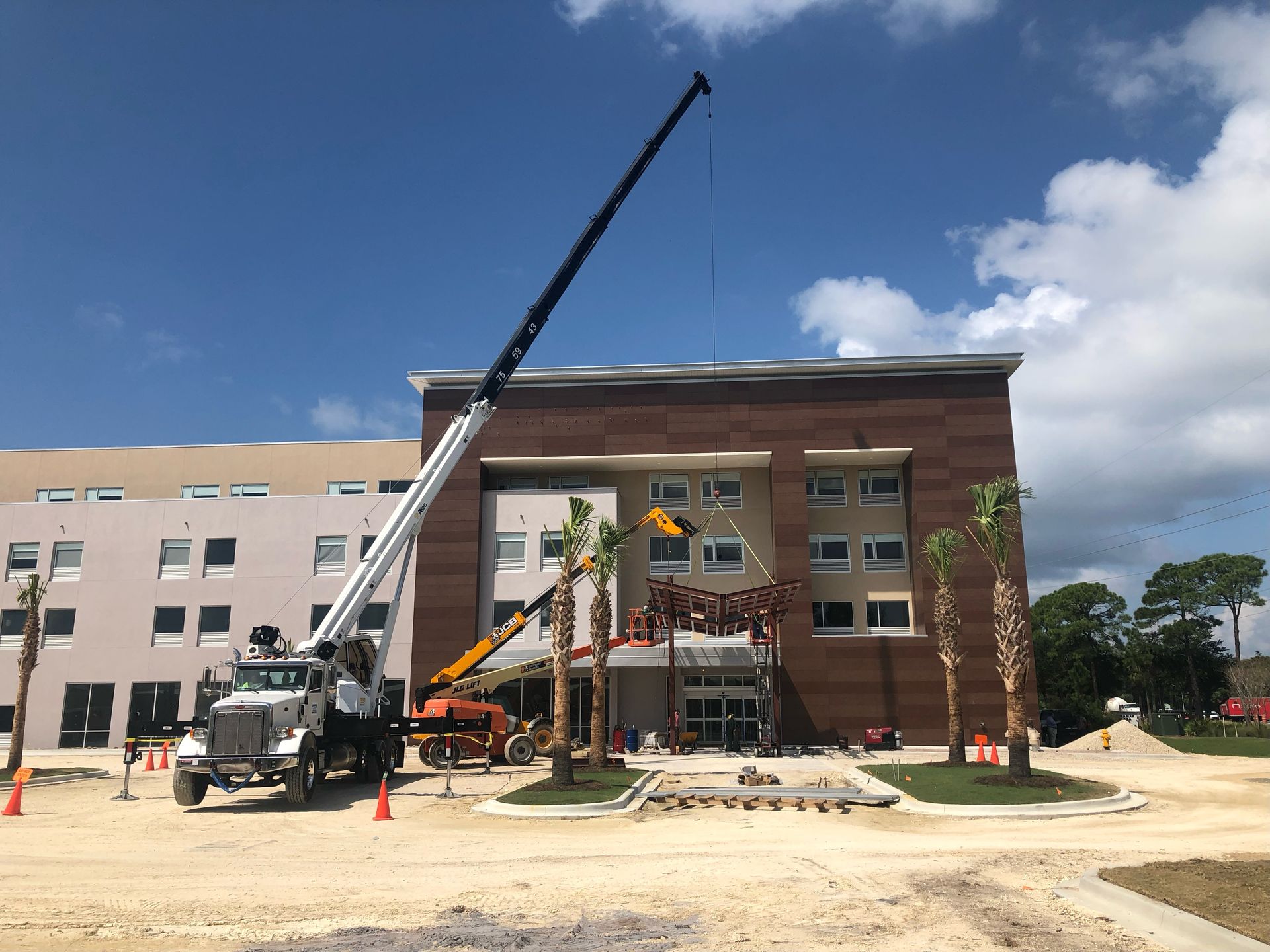 A large building under construction with a crane in front of it