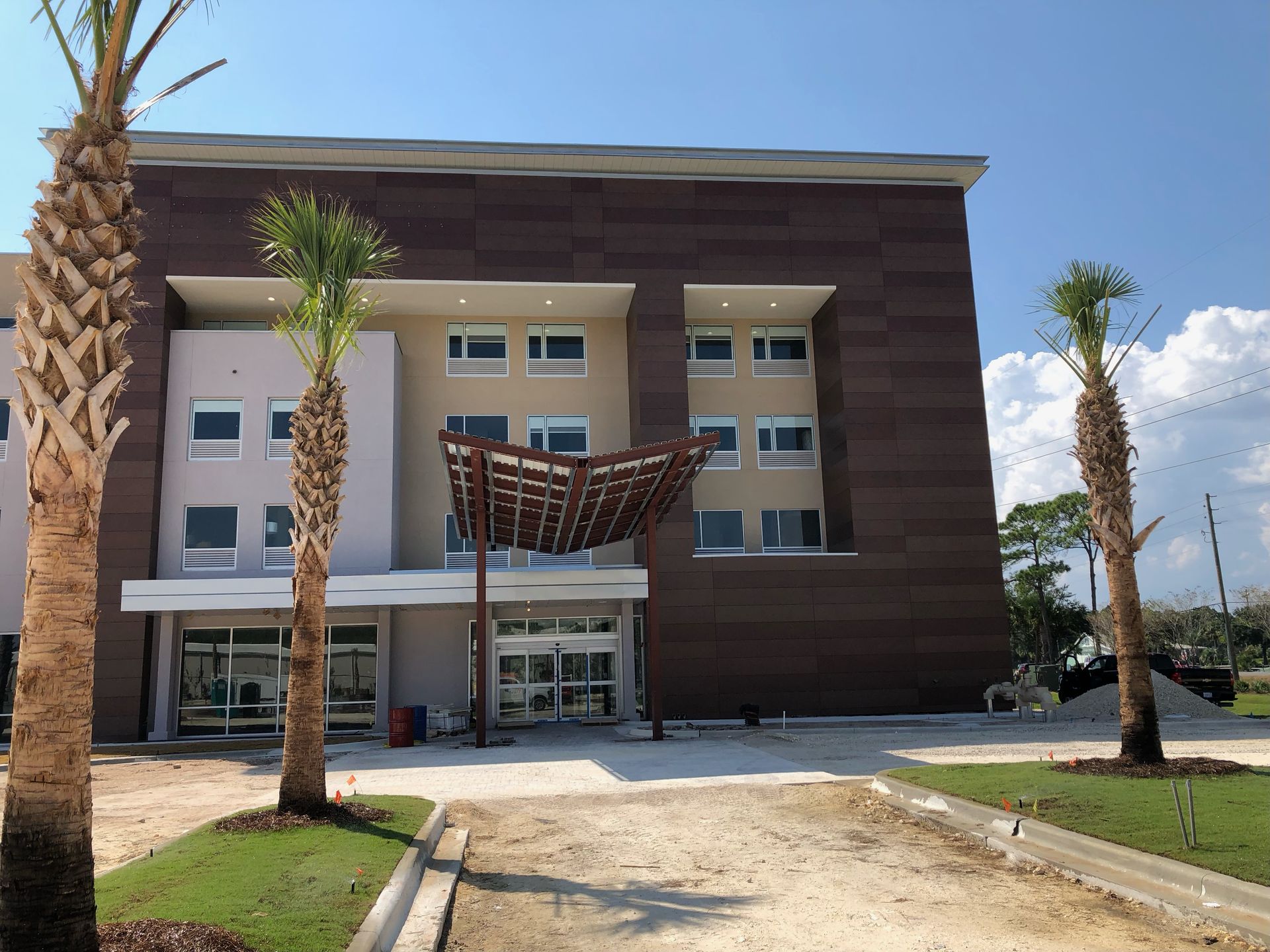 A large building with palm trees in front of it