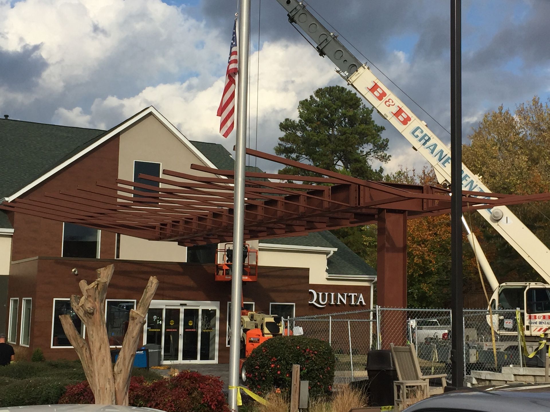 A crane is in front of a building