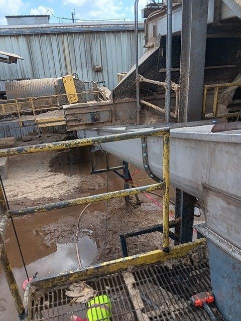 A man is working on a machine in a factory.