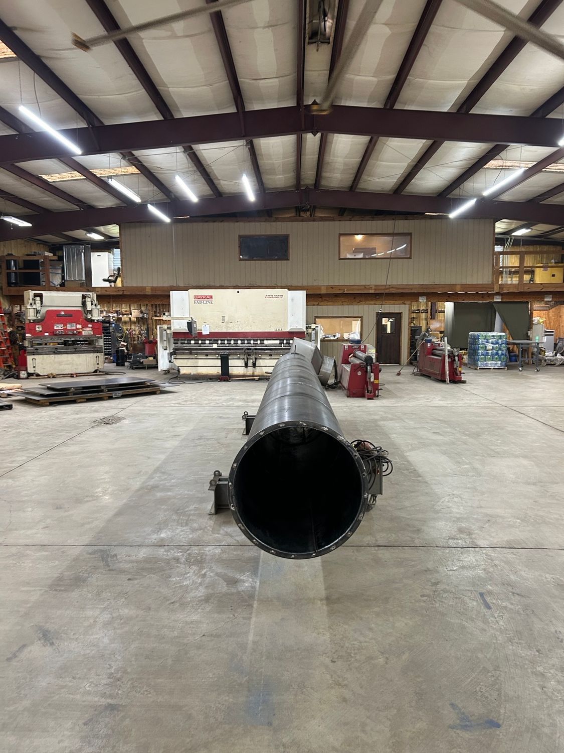 A large metal pipe in the middle of a factory