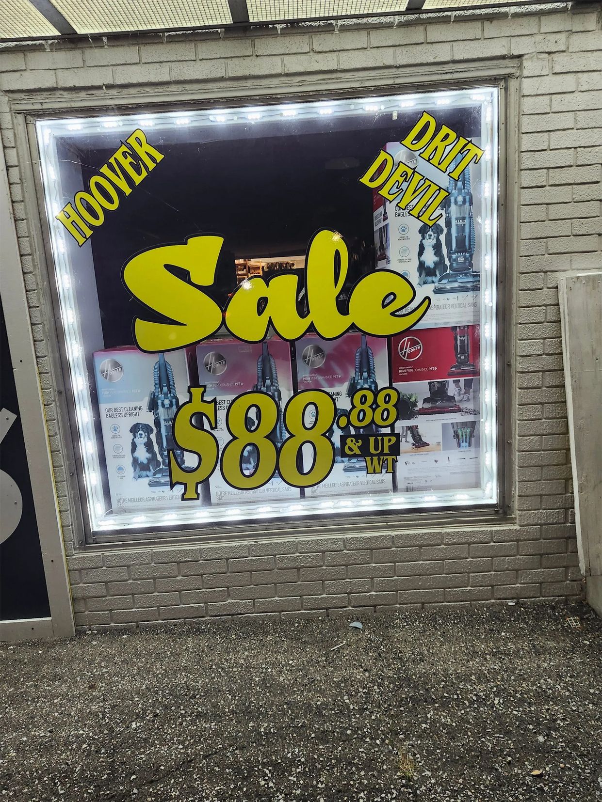 Store window sale sign with $88 price on a brick building.
