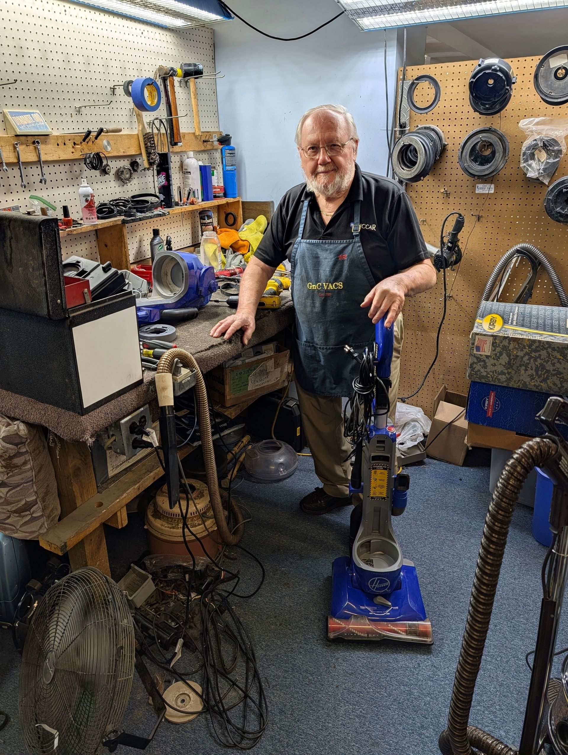 Person standing in a cluttered workshop
