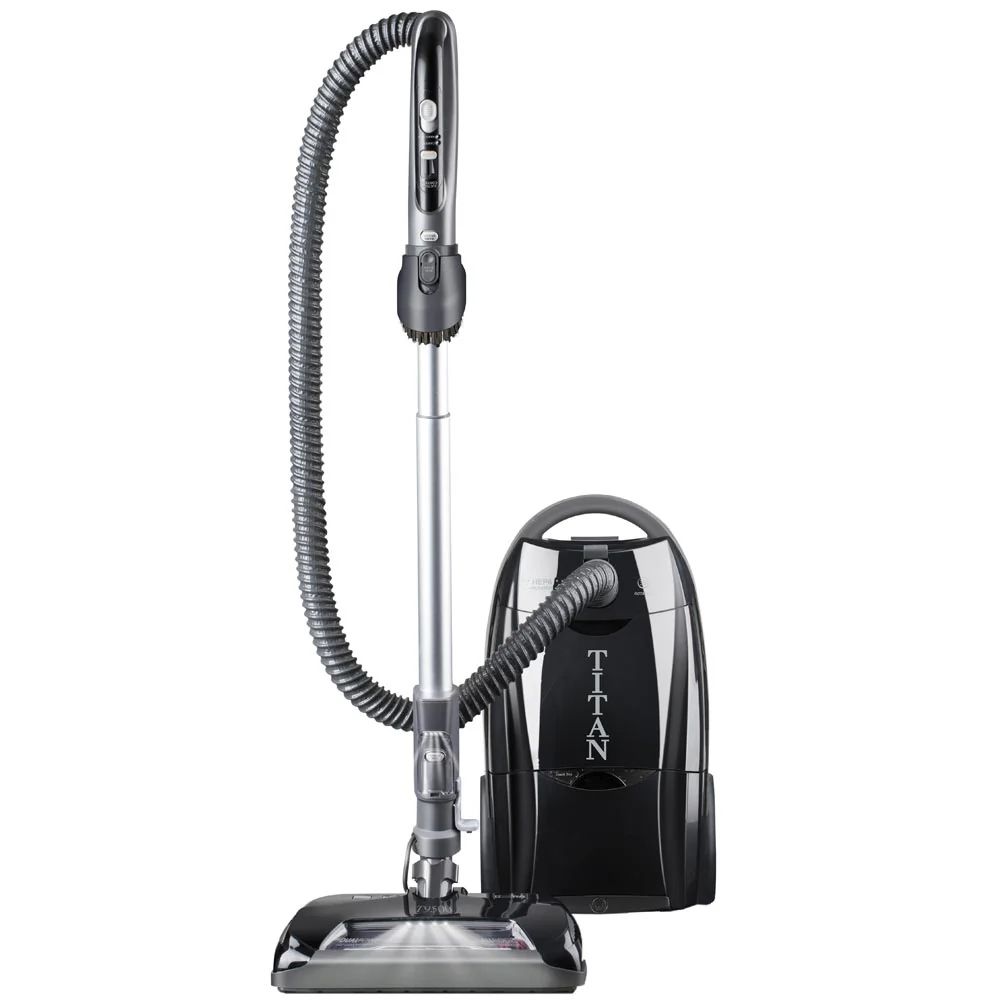 Black upright vacuum cleaner with hose and canister on a white background