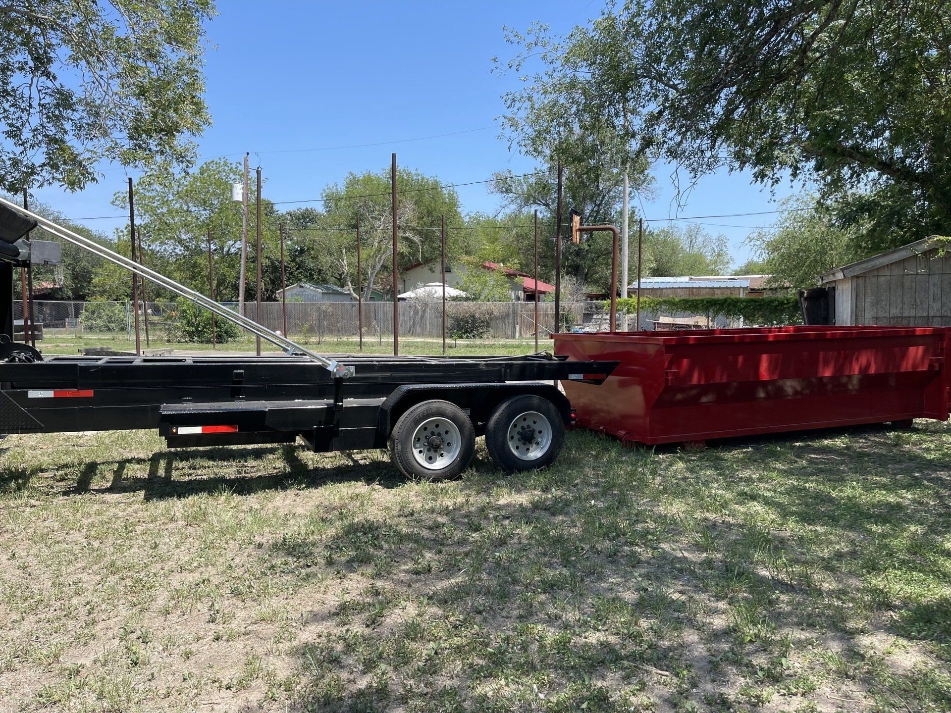 Trailer and a red dumpster