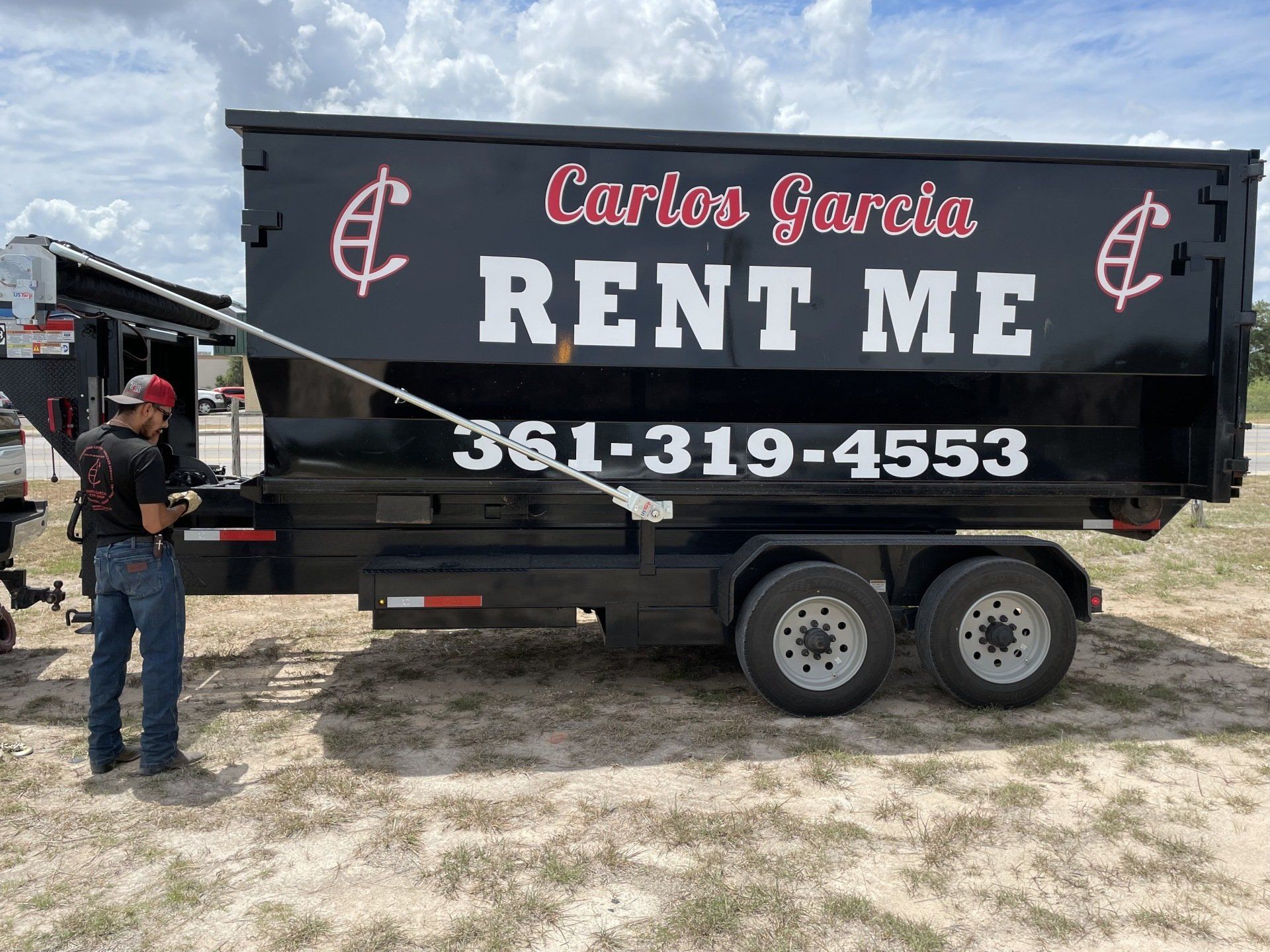 Black dumpster on a trailer